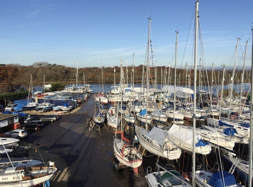 Masts and boats ashore at Wilson's Boatyard on a clear day.